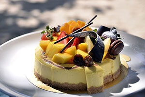 Cheesecake with tropical fruit and edible decorations